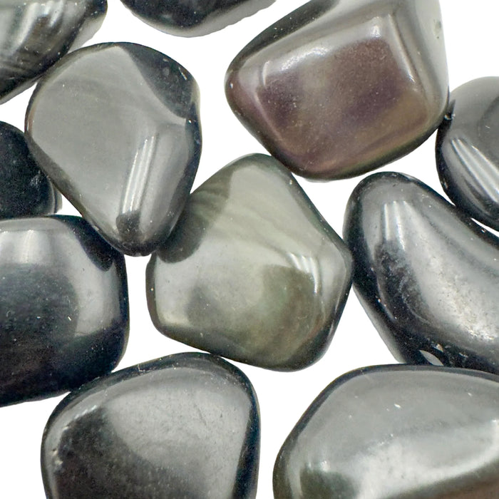 Edge view of Rainbow Obsidian tumbled stone, showing color depth.