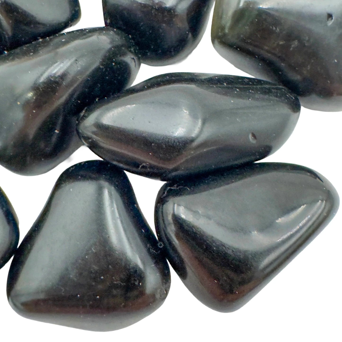 Palm-scale view of a Rainbow Obsidian tumbled stone held against natural backdrop, sourced from Mexico.
