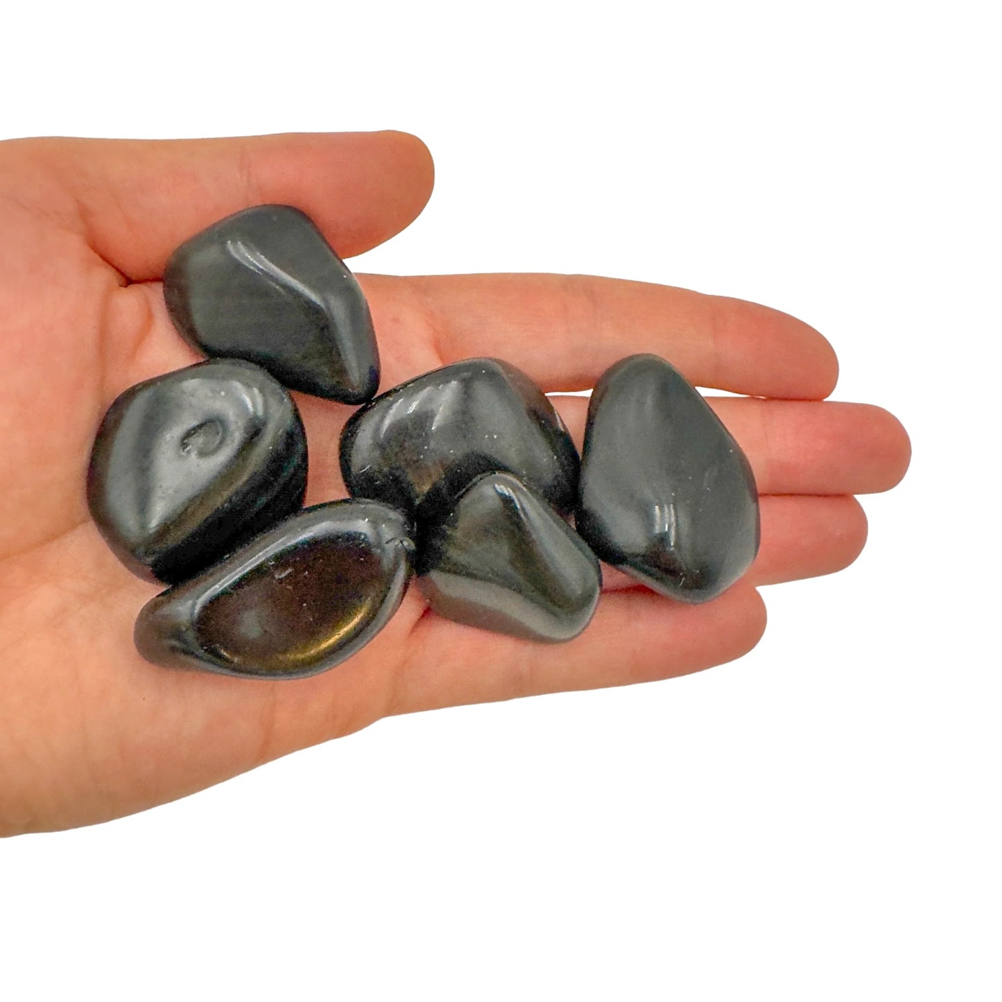 Lifestyle still of Rainbow Obsidian tumbled stone, showing the full body of the piece.