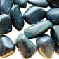 Magnified detail of black Rainbow Obsidian tumbled stone, showing natural sheen.