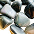 Top angle of Rainbow Obsidian tumbled stone, from Mexico.