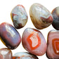 Profile view of Red Agate tumbled stone, sourced from Zimbabwe, linked to Grounding.