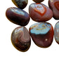 Underside detail of Red Agate tumbled stone, traditionally used for Grounding.