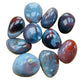 Quiet study of Red Agate tumbled stone, captured against a quiet backdrop.