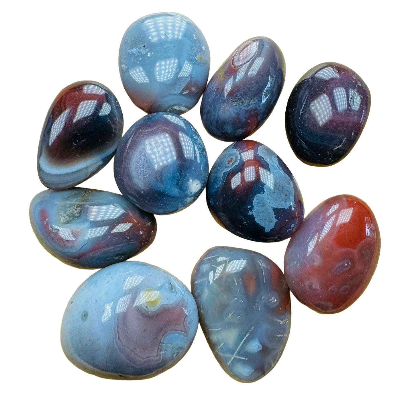 Quiet study of Red Agate tumbled stone, captured against a quiet backdrop.