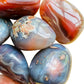 Reverse angle of Grade AA Red Agate palm stone, showing soft luster.