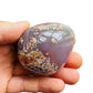 Detail shot of Grade AA Red Agate palm stone under natural light