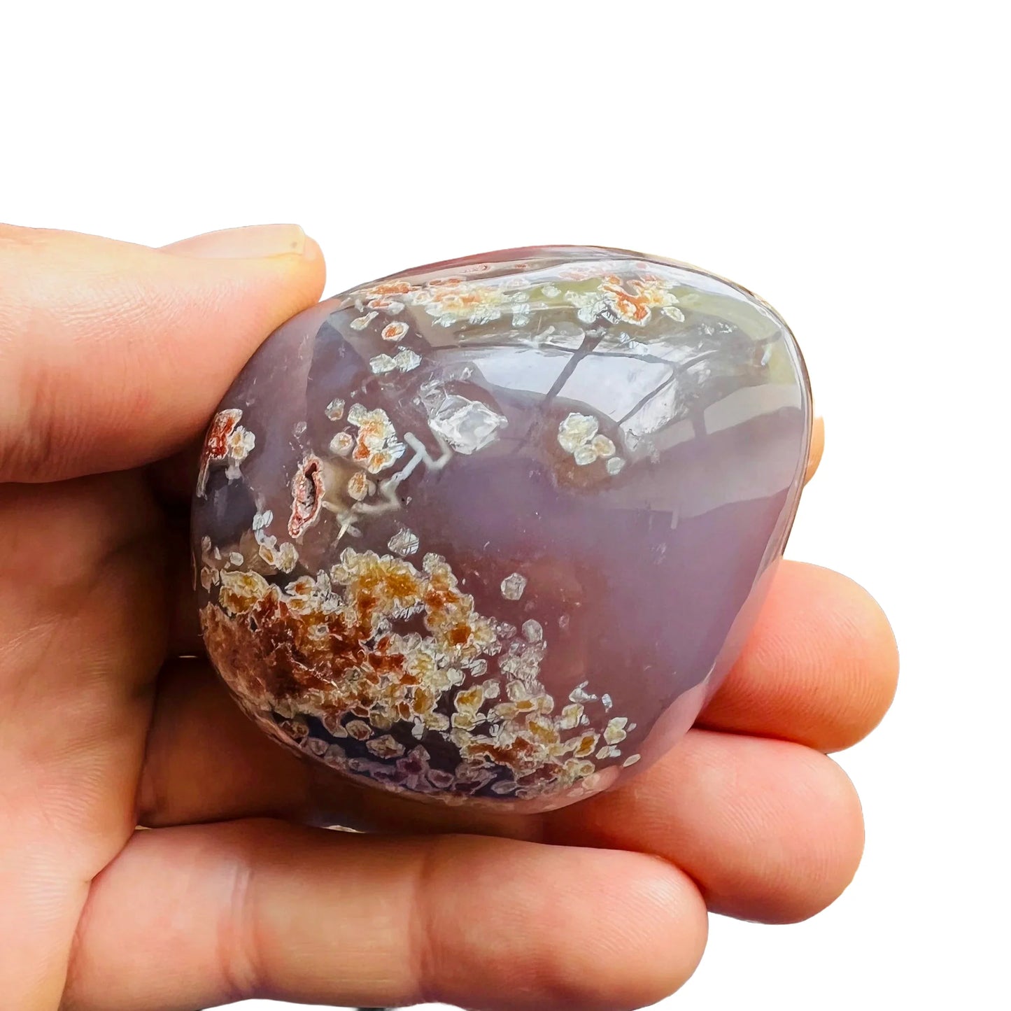 Detail shot of Grade AA Red Agate palm stone under natural light