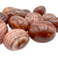 Up-close view of Red Aragonite tumbled stone, often kept for Energy and Confidence.