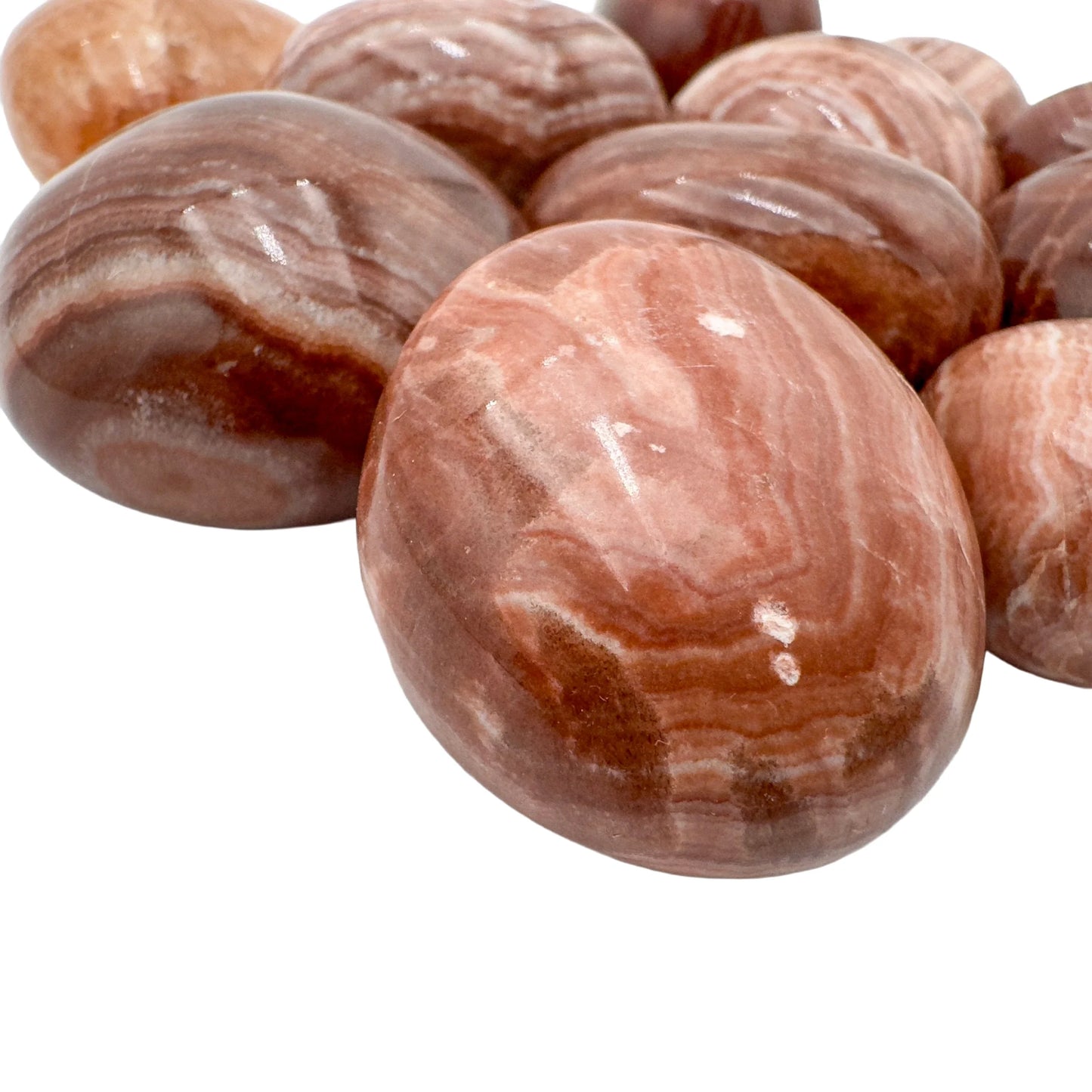 Size comparison with a single Red Aragonite tumbled stone Peru-sourced.
