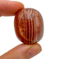 Back view of Grade AAA Red Aragonite tumbled stone showing natural surface