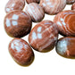 Full profile of Grade AAA Red Aragonite tumbled stone ready to ship from Beyond Bohemian