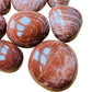 Full profile of Grade AAA Red Aragonite tumbled stone ready to ship from Beyond Bohemian