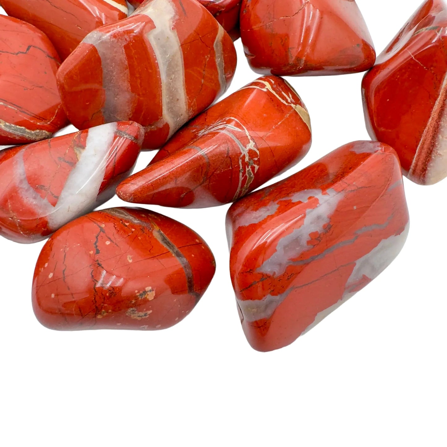 Edge-on view of Grade AA Red Jasper tumbled stone, hand-selected from Northern Cape, South Africa, showing earthy tone.