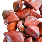 Side perspective of Red Jasper tumbled stone, carried for Grounding, showing characteristic finish.