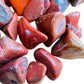 Top view of Red Jasper tumbled stone, carried for Grounding, showing earthy tone.