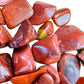 Underside detail of Red Jasper tumbled stone, traditionally used for Grounding and Energy, showing subtle veining.
