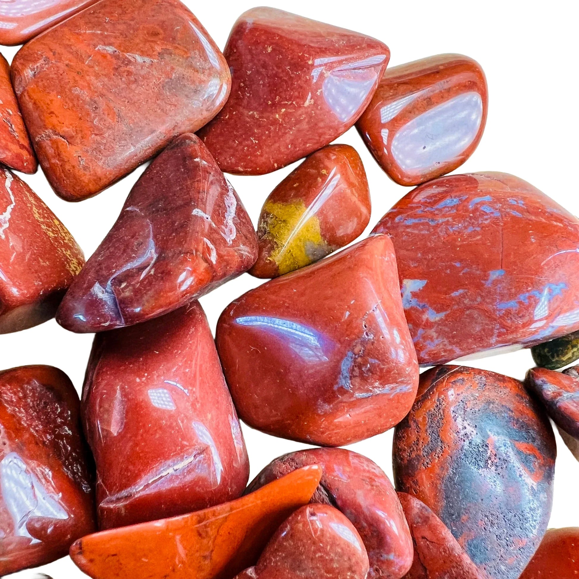 Underside detail of Red Jasper tumbled stone, traditionally used for Grounding and Energy, showing subtle veining.