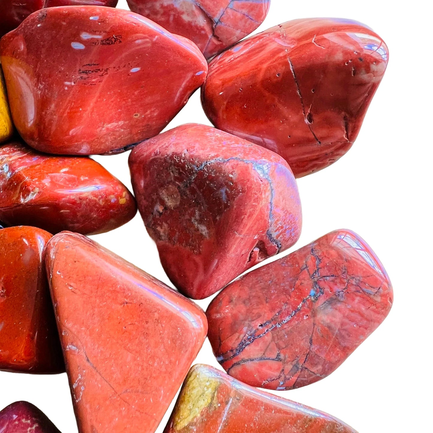 Near view of Red Jasper tumbled stone, showing earthy tone, carried for Grounding.