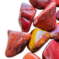 Side angle of Grade AA Red Jasper tumbled stone, sourced from Sofia, Madagascar, showing soft luster.