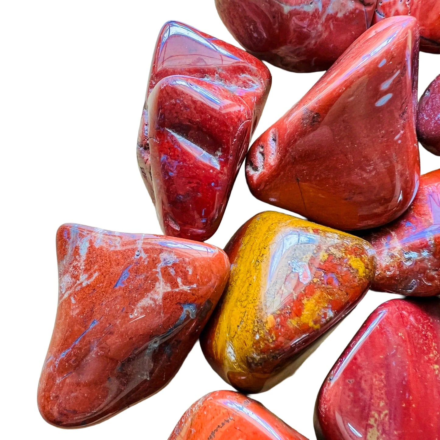 Side angle of Grade AA Red Jasper tumbled stone, sourced from Sofia, Madagascar, showing soft luster.
