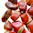 Lateral view of Red Jasper tumbled stone, from South Africa, showing natural sheen.