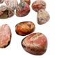 Underside view of Grade A Rhodochrosite tumbled stone, often paired with practices around Emotional Healing and Love.