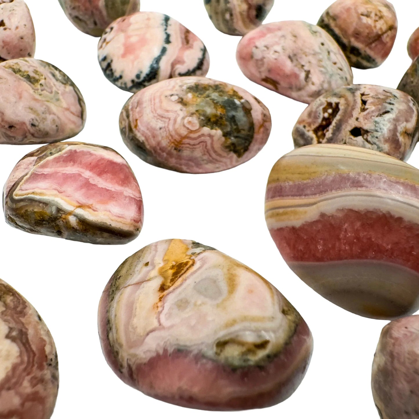 In-hand view of a single Rhodochrosite tumbled stone from Catamarca Province, Argentina.