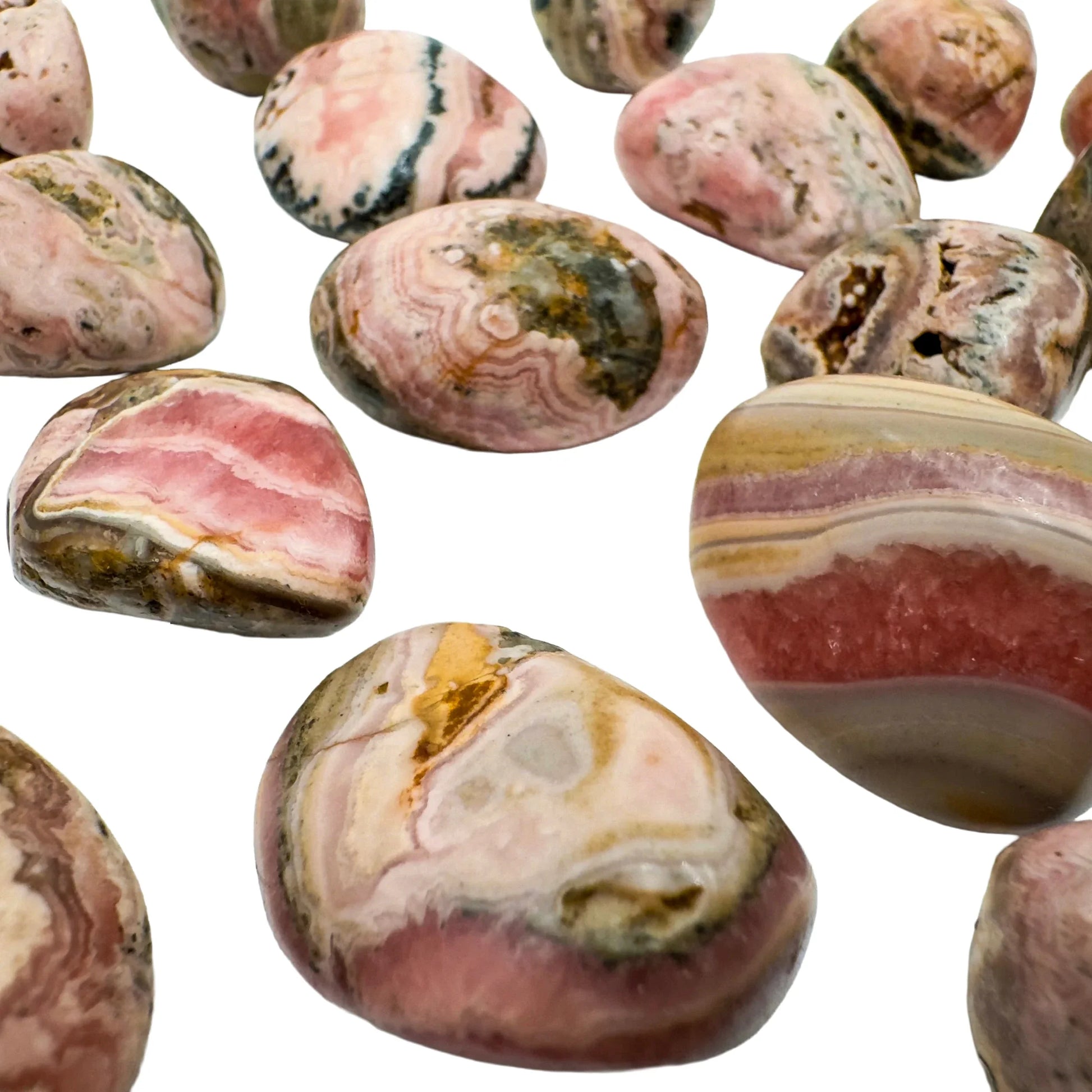 In-hand view of a single Rhodochrosite tumbled stone from Catamarca Province, Argentina.