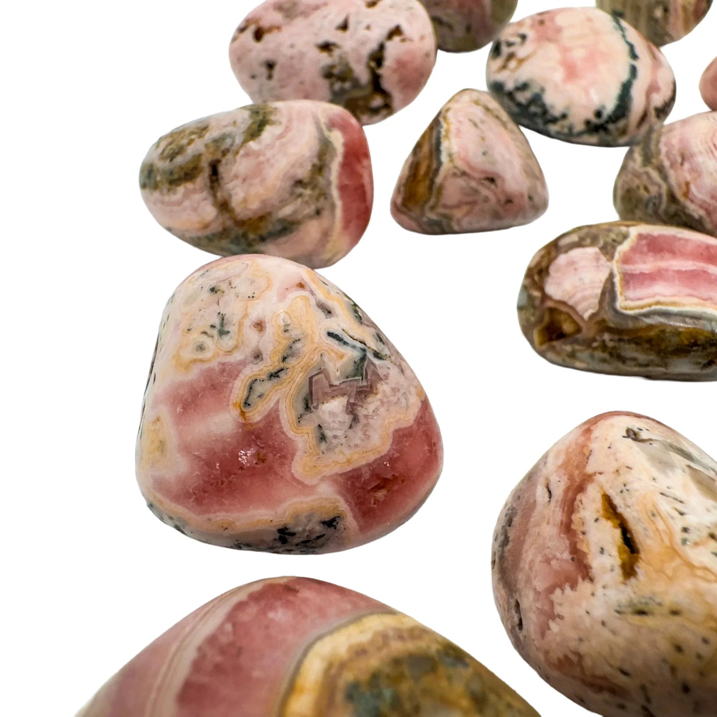 Daylight detail of Rhodochrosite tumbled stone, from Catamarca Province, Argentina, with surface texture in view.