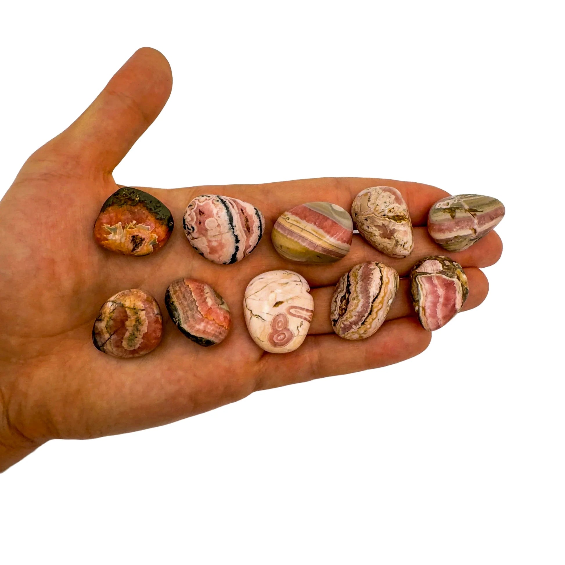 Detail shot of Grade A Rhodochrosite tumbled stone under natural light