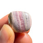 Full profile of Grade A Rhodochrosite tumbled stone ready to ship from Beyond Bohemian