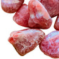 Overhead angle of Rhodochrosite tumbled stone, often paired with practices around Emotional Healing and Love.
