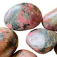 Near view of Rhodonite freeform, sourced from Zimbabwe, showing natural texture.
