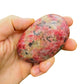 Lifestyle view of a Rhodonite freeform, sourced from Masvingo, Zimbabwe.