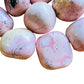 Detail capture of Rhodonite tumbled stone, showing characteristic color, from Ancash, Peru.