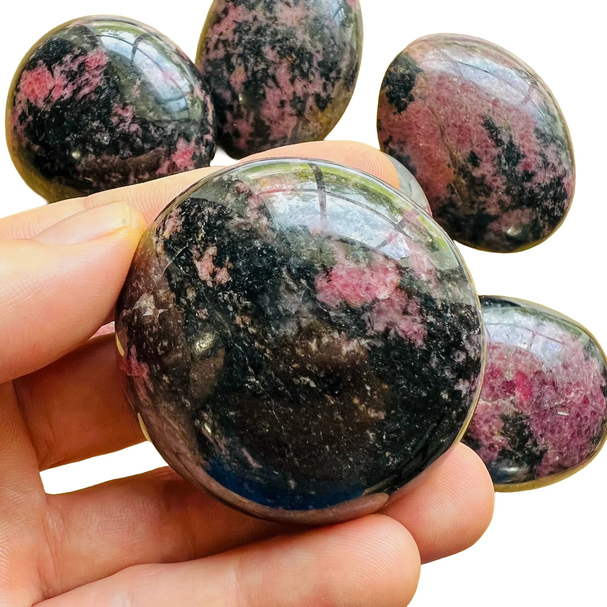 Daylight view of a Rhodonite palm stone worked with for Emotional Healing, from Madagascar.