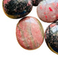Back view of Grade AA Rhodonite palm stone showing natural surface