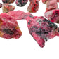 Side-on view of Rhodonite raw stone, sourced from Masvingo, Zimbabwe.