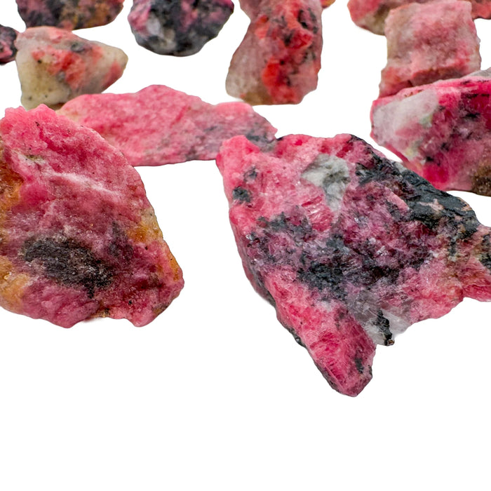 Side-on view of Rhodonite raw stone, sourced from Masvingo, Zimbabwe.