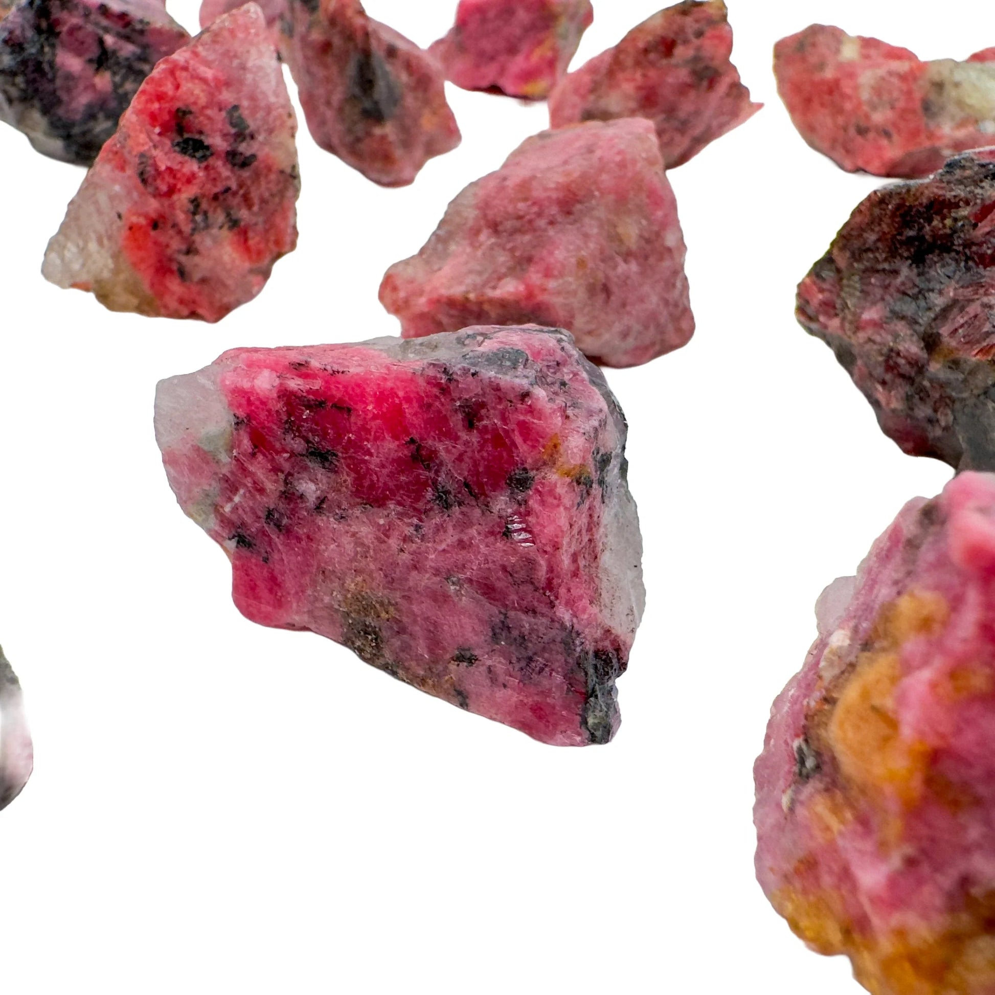 Overhead view of Rhodonite raw stone, showing honest grain.