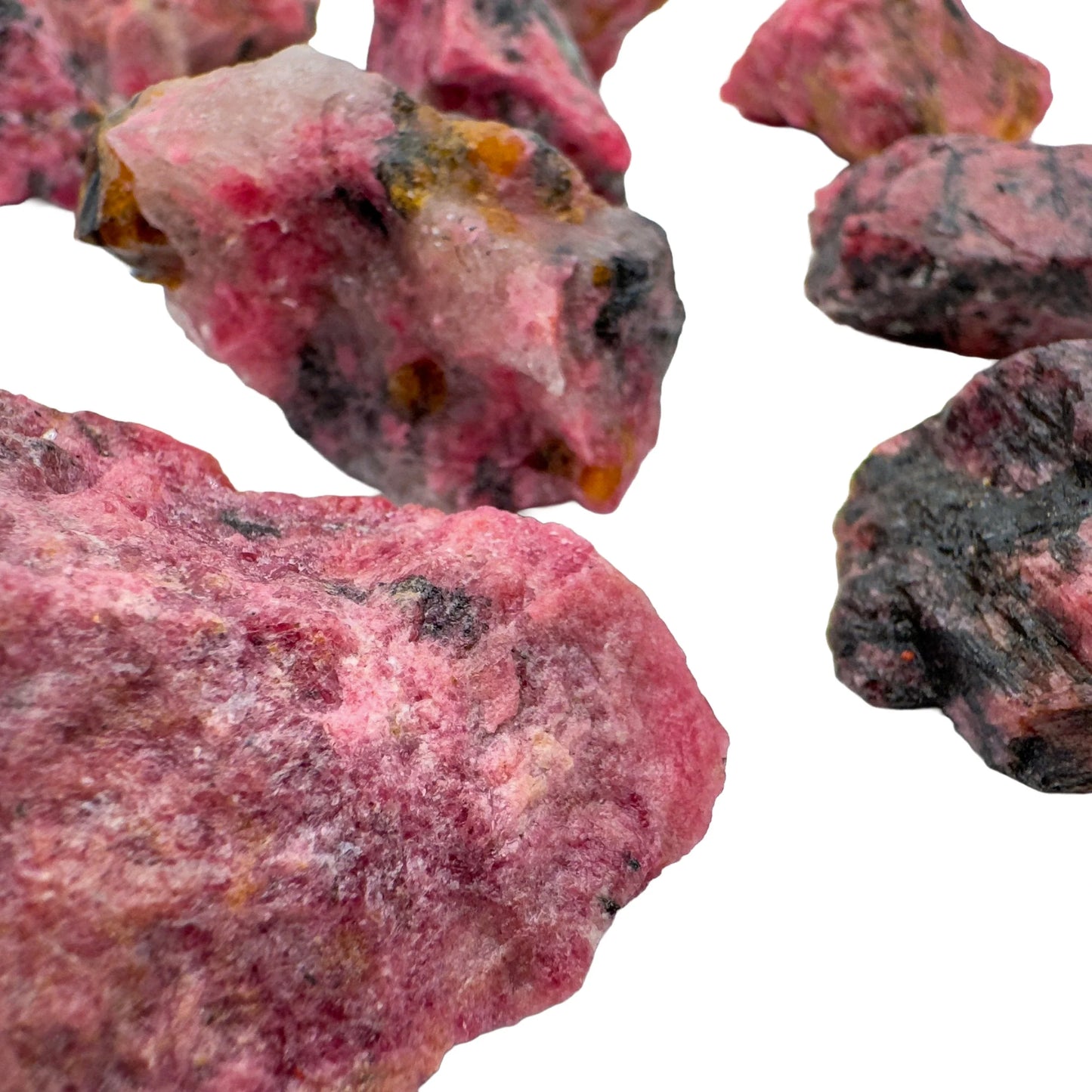 Plan view of Rhodonite raw stone, Zimbabwe-sourced, often worked with for Emotional Healing and Love.