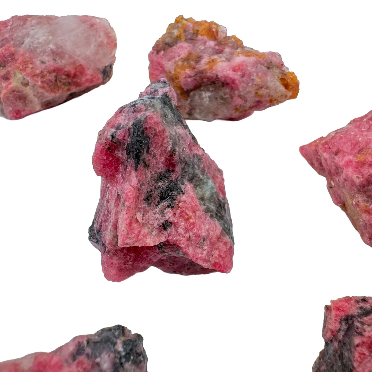 Quiet study of Rhodonite raw crystal, from Masvingo, Zimbabwe, in the warmth of daylight.
