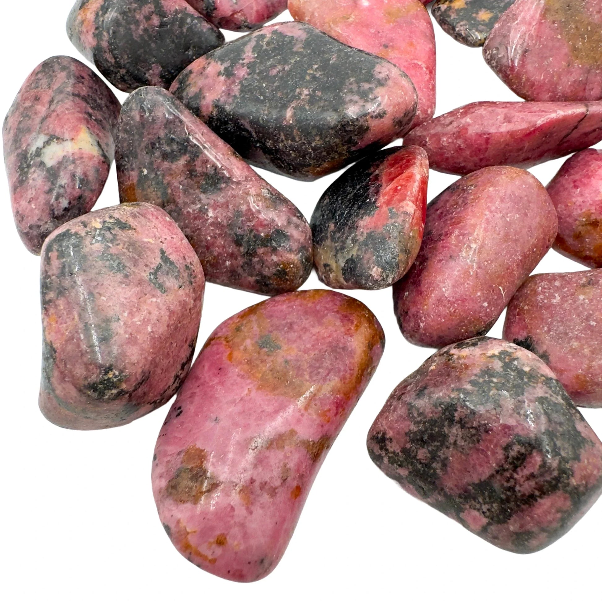 Lateral view of Grade AA Rhodonite tumbled stone, showing natural inclusions, hand-selected from Masvingo, Zimbabwe.