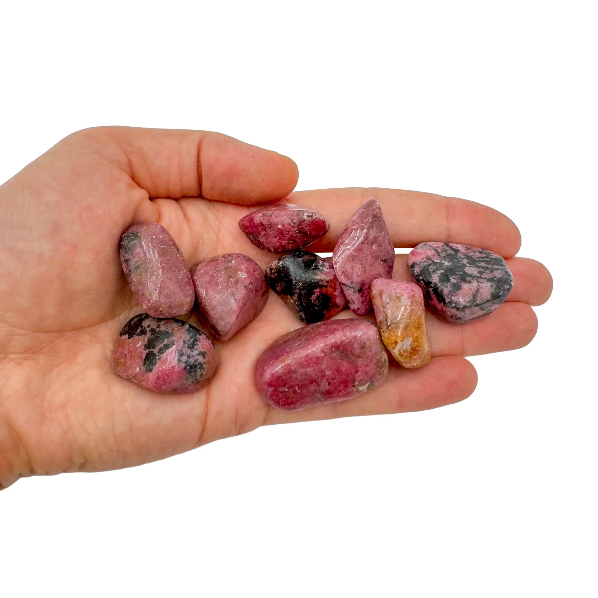 Natural light view of one Rhodonite tumbled stone for scale, from Masvingo, Zimbabwe.