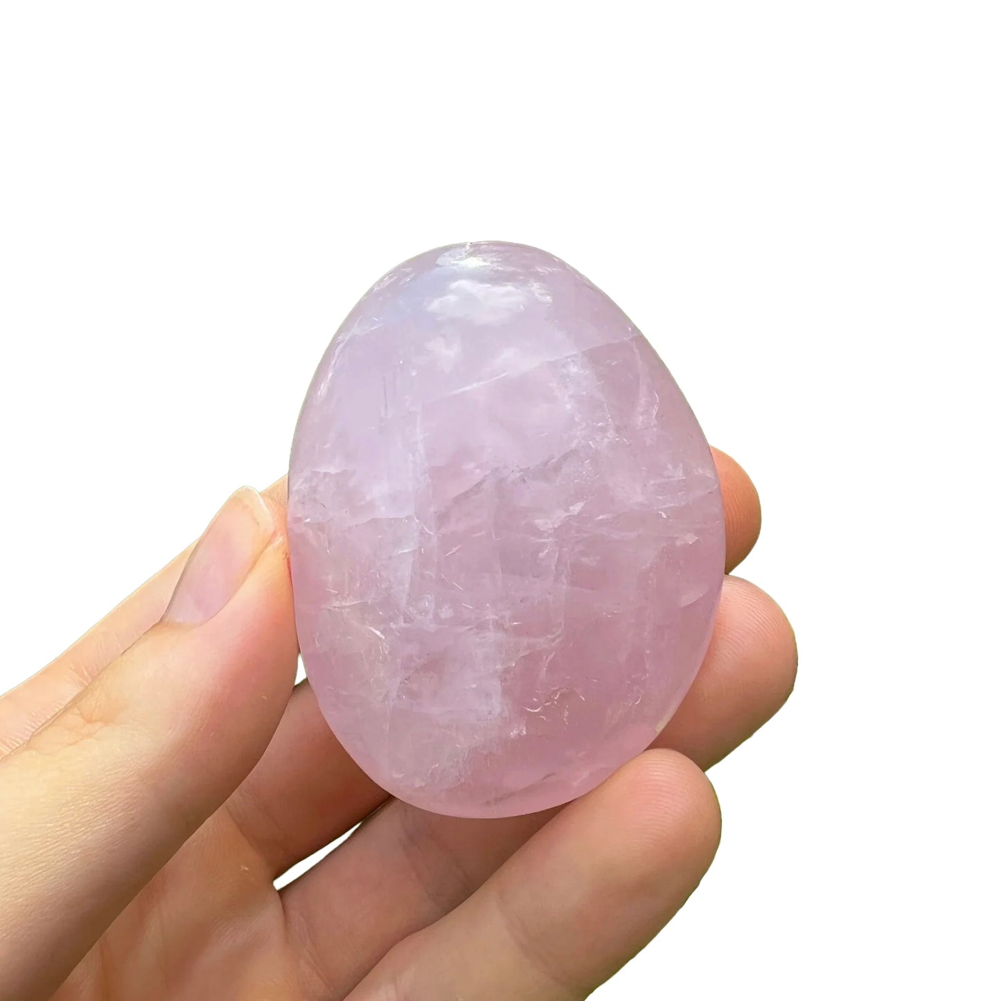Profile view of pink Rose Quartz palm stone, showing earthy tone, turned to for Love.