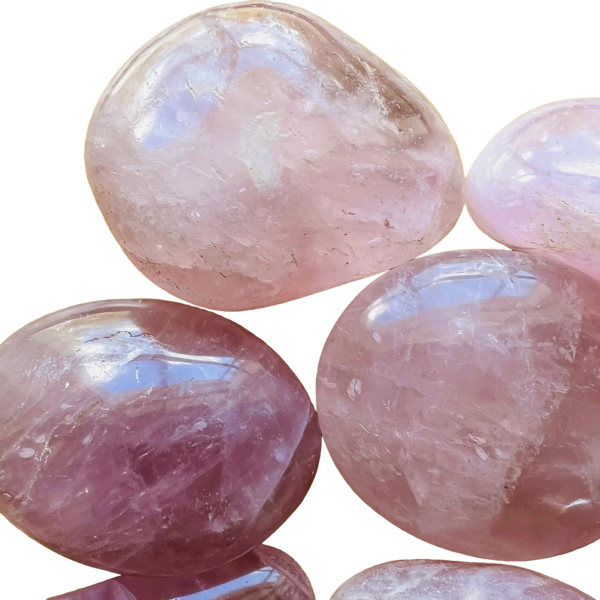 Natural light context of Rose Quartz palm stone, associated with Self Love, showing the full body of the piece.