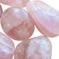 Back view of Grade AA Rose Quartz palm stone showing natural surface