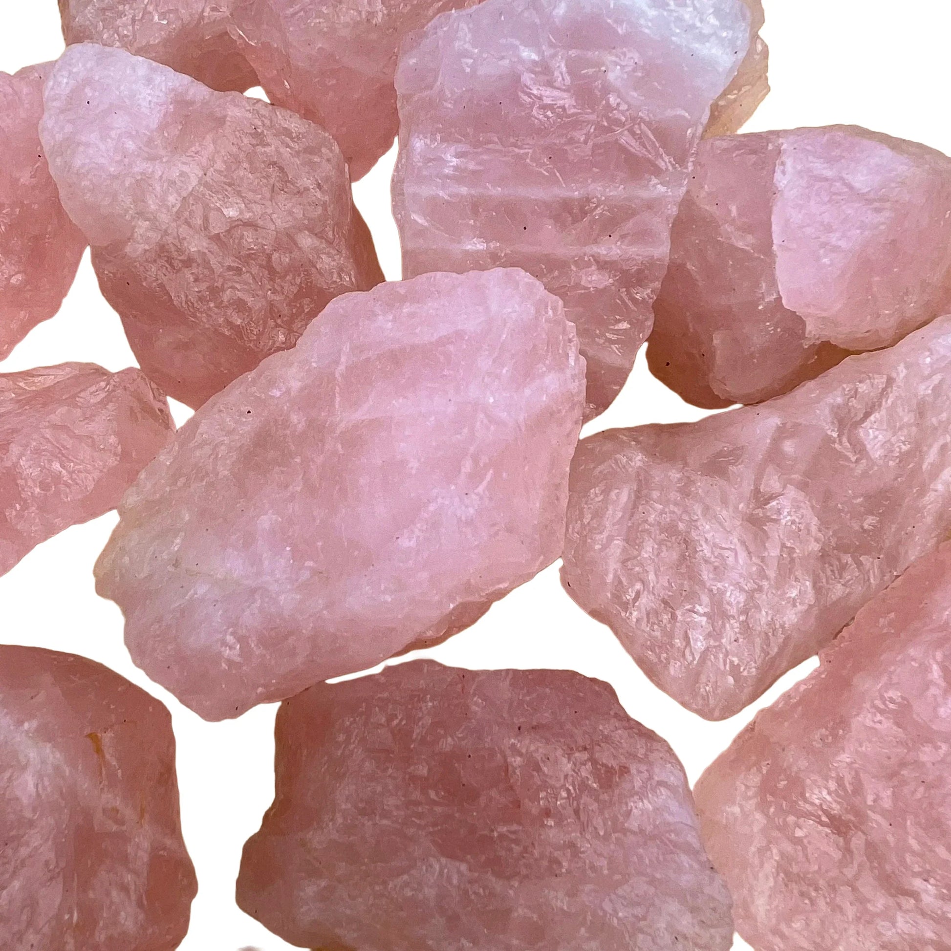 Side perspective of pink Rose Quartz raw stone, showing subtle veining.