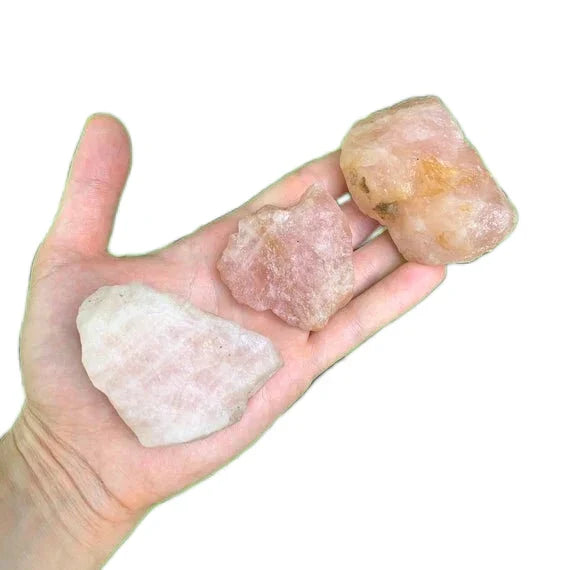 Palm-scale view of a single Rose Quartz raw stone hand-selected from South Dakota, United States.